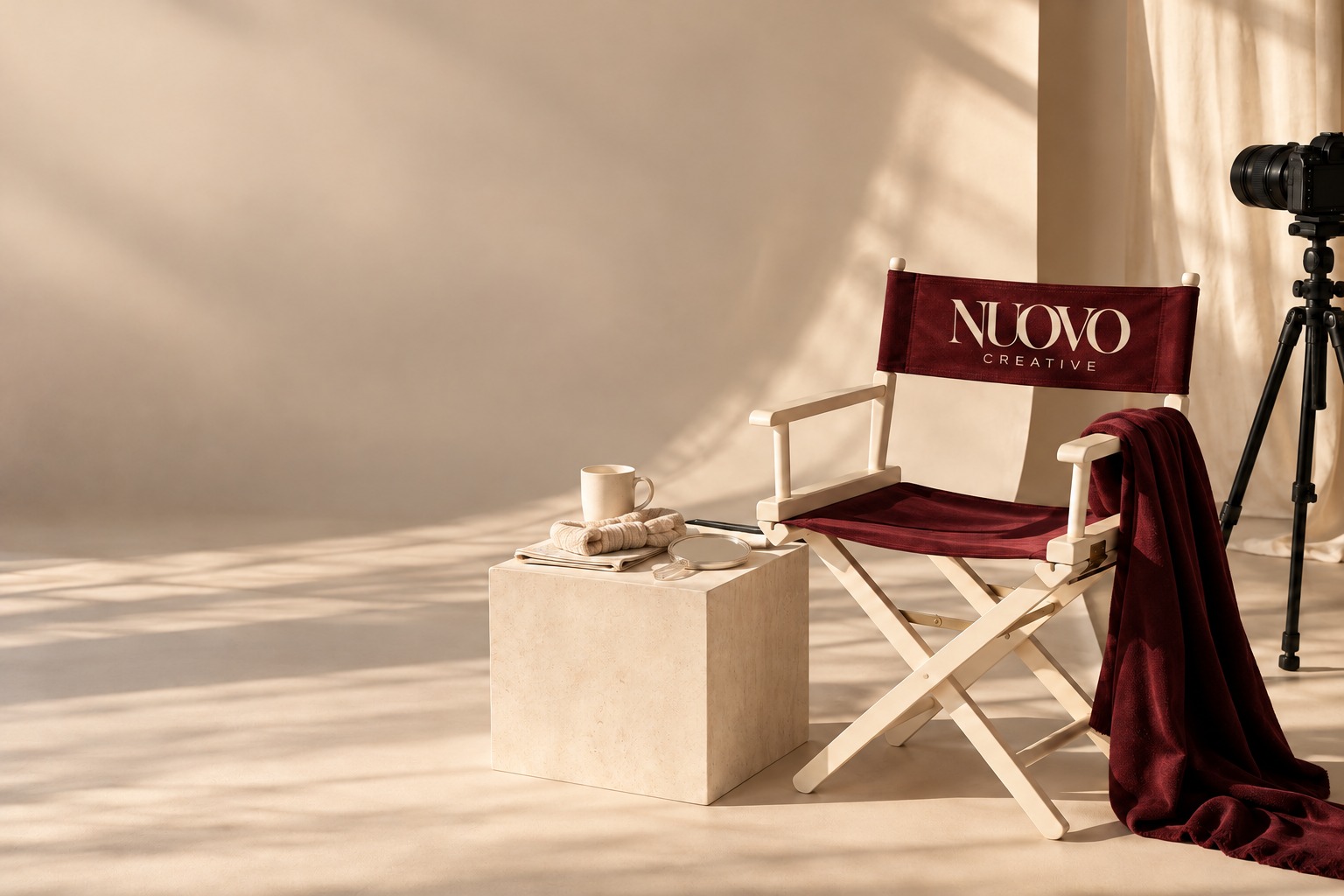 A warm beige content photoshoot studio with a director’s chair, personalised product props and a camera